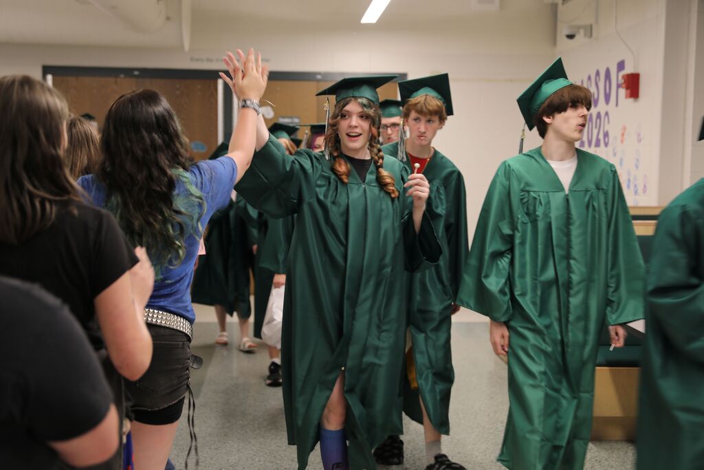 seniors walking through the high school and giving high fives