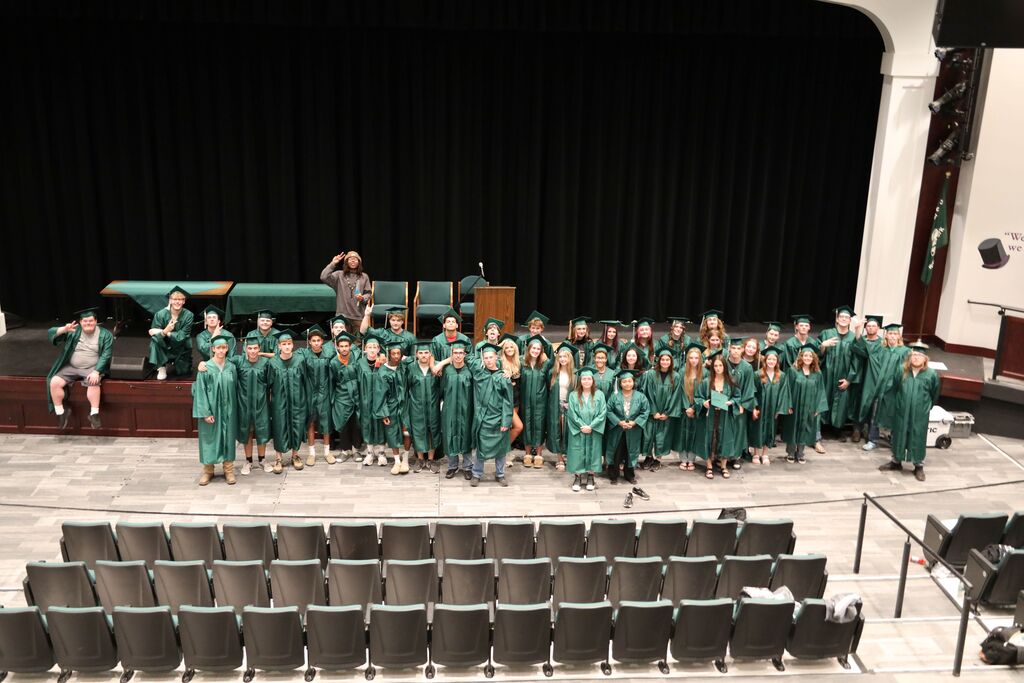 a group photo from high above in the auditorium 