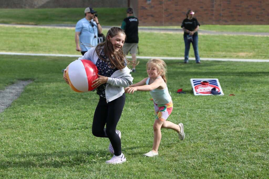a student chasing another student with a beach ball