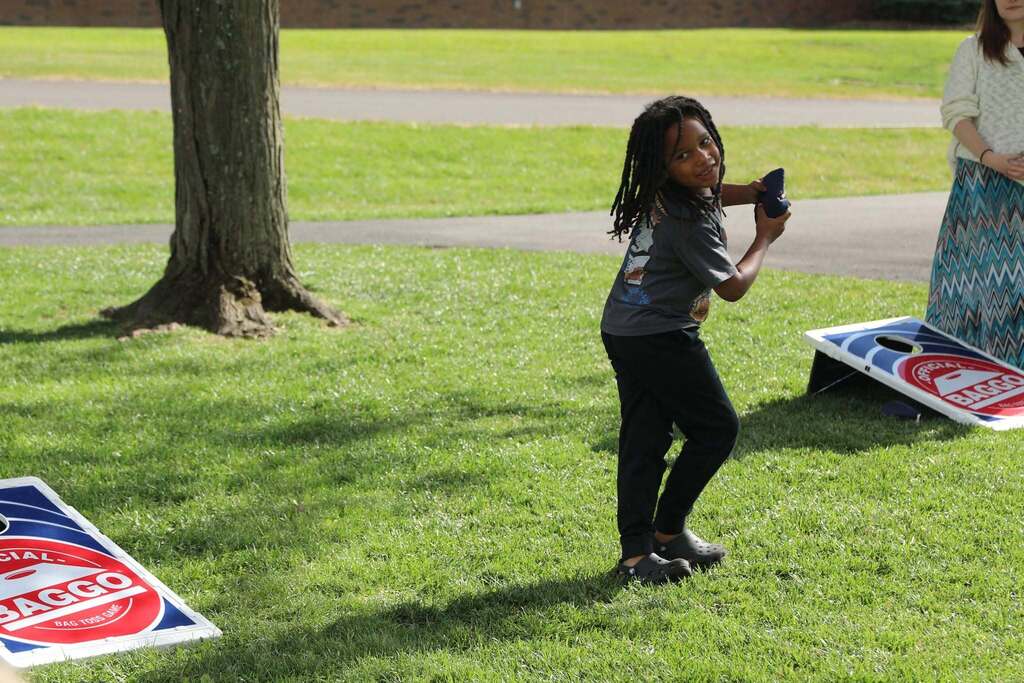a student playing cornhole