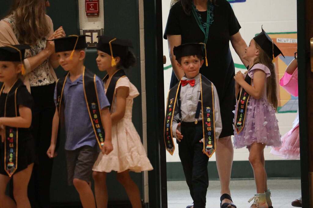 the students entering the gym for the ceremony
