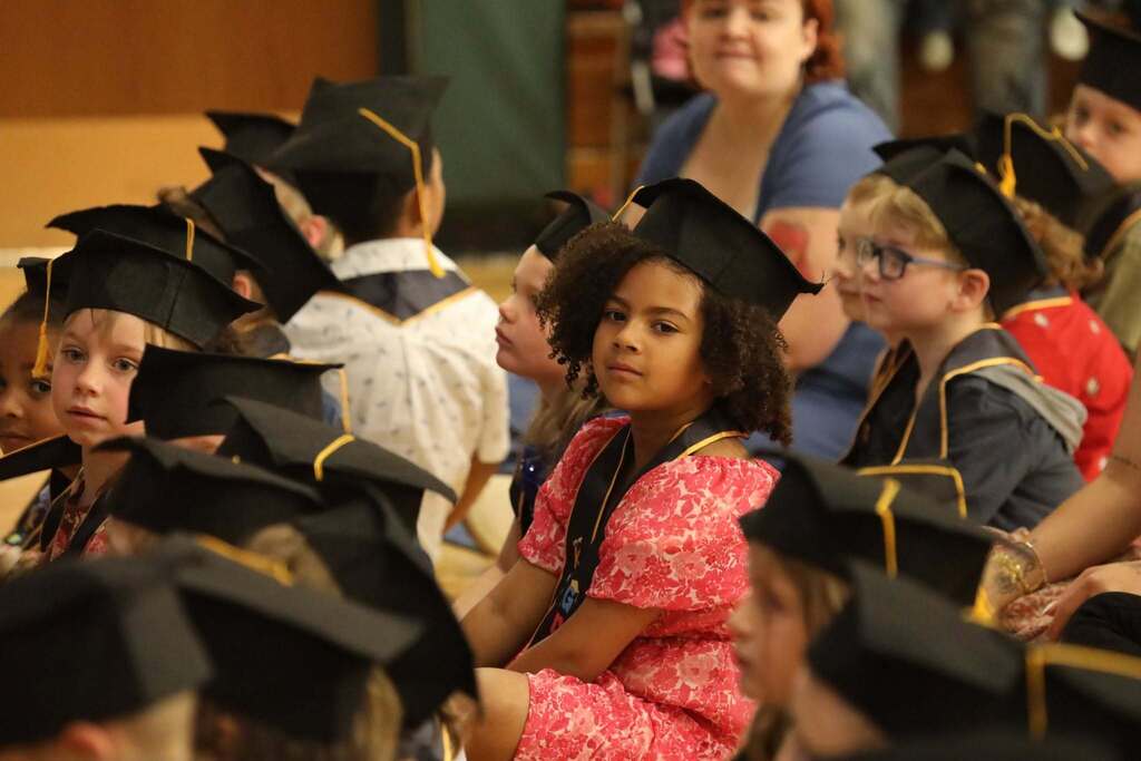 a student sitting waiting for the ceremony to begin 