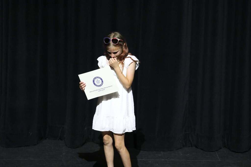 a student holding the NYS AG Award