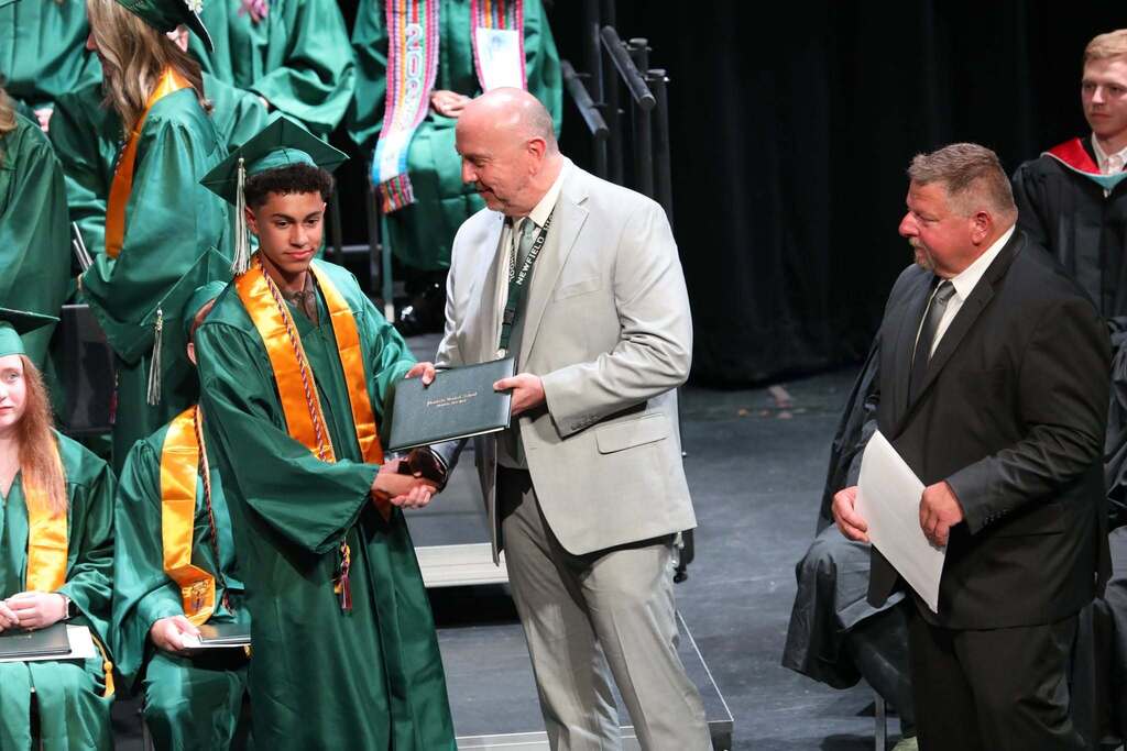 a student receiving their diploma