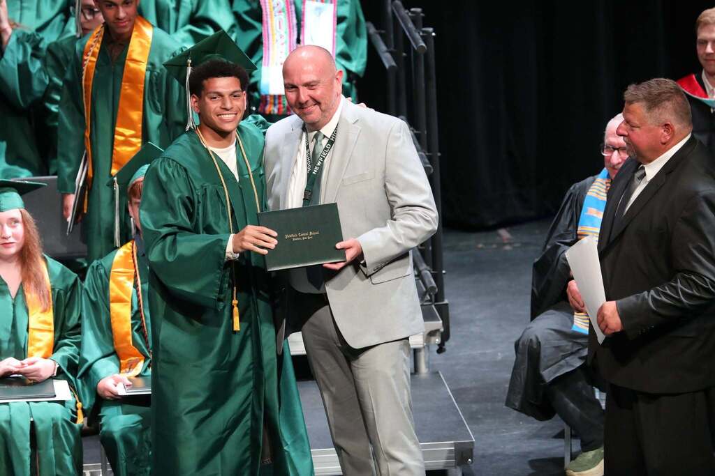 a student receiving their diploma