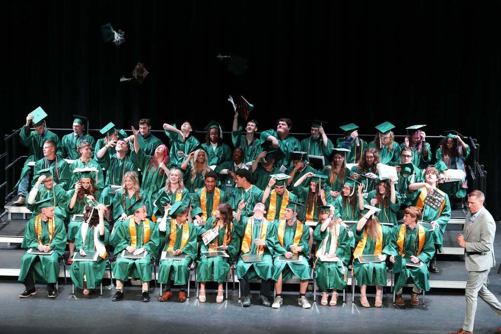 all the graduates throwing their hats