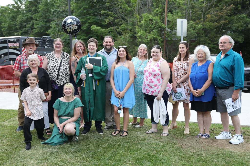 a family posing for a photo in the front lawn