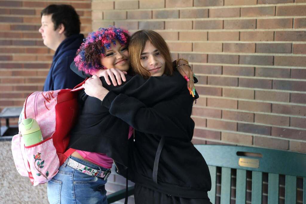 two students hugging each other