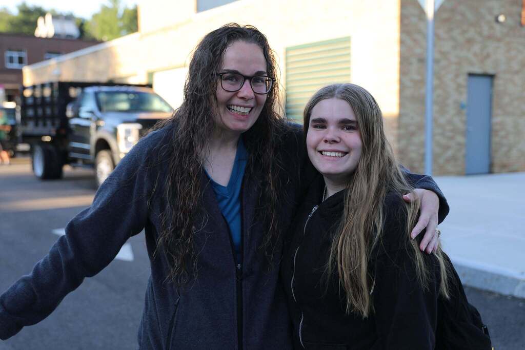 a student and staff and/or parent posing for a photo