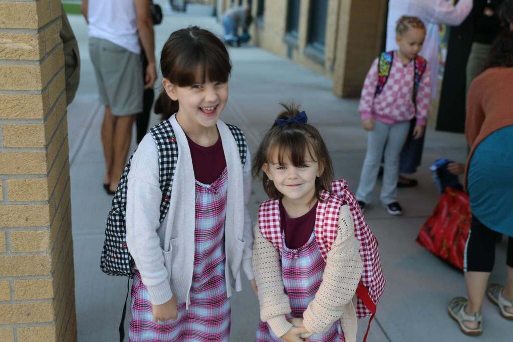 two students smiling at the camera