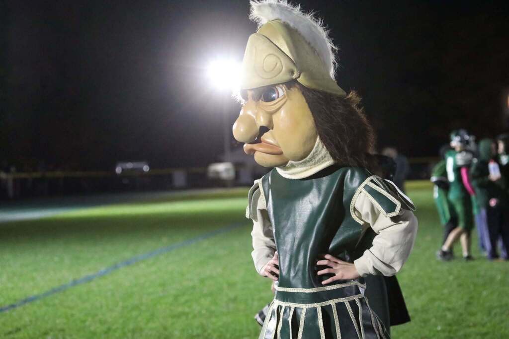the trojan mascot standing on the sidelines of the game