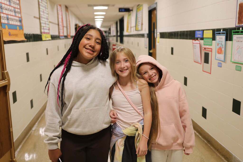 three students posing for the camera
