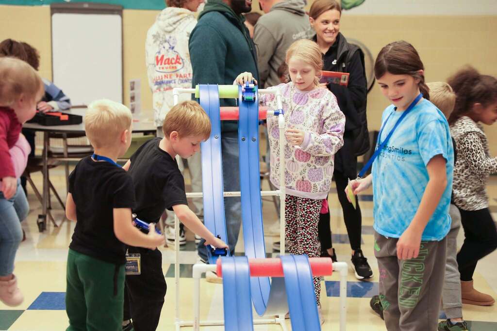 students playing with a race track