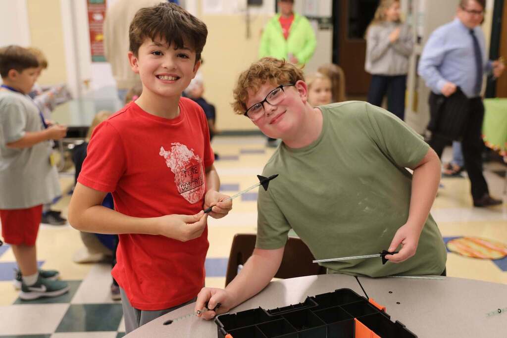 two students smiling at the camera
