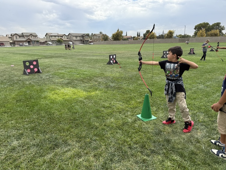 Fourth graders doing archery.