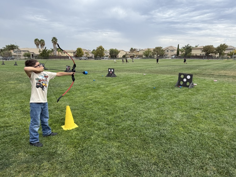 Fourth graders doing archery.