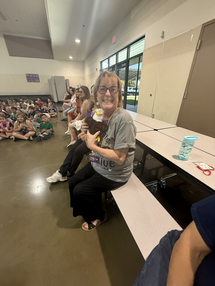 teacher holding stuffed eagle