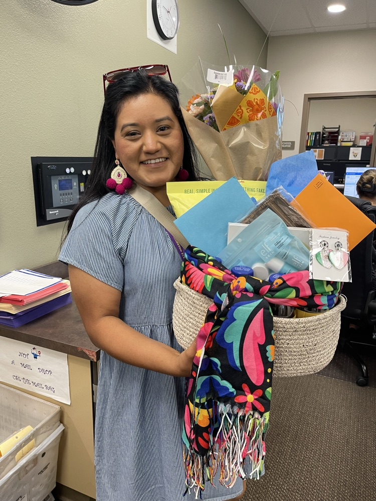 teacher holding a gift basket