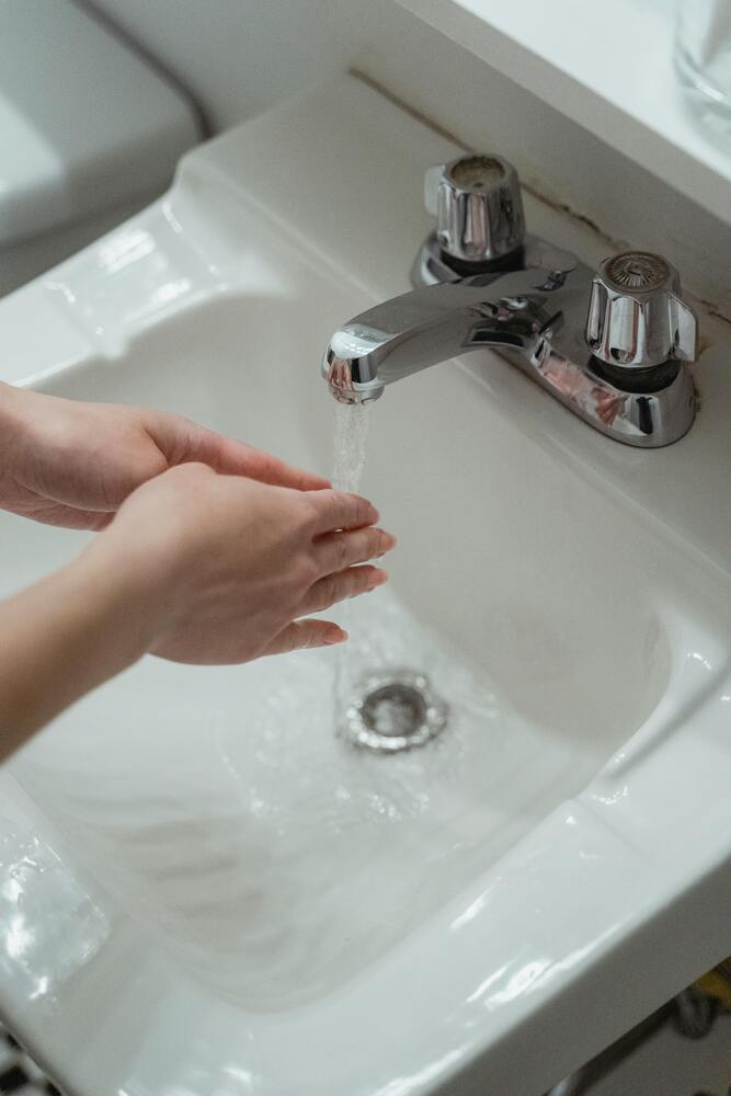 washing hands in sink