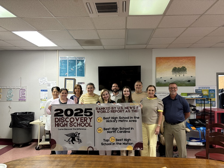 DHS staff standing proudly with the banner