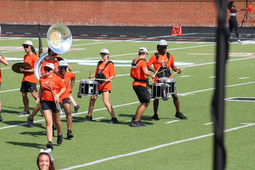 Peyton marches on the field with the band