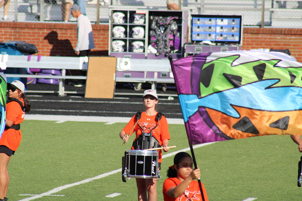 Peyton marches on the field with the band