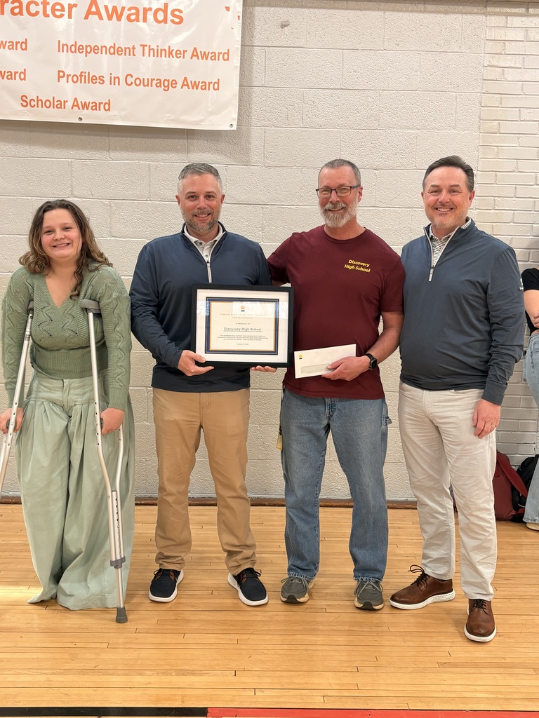Peoples Bank reps present Mr. Whitener and student Grace Robinson for winning their Giving Back to Our Schools event
