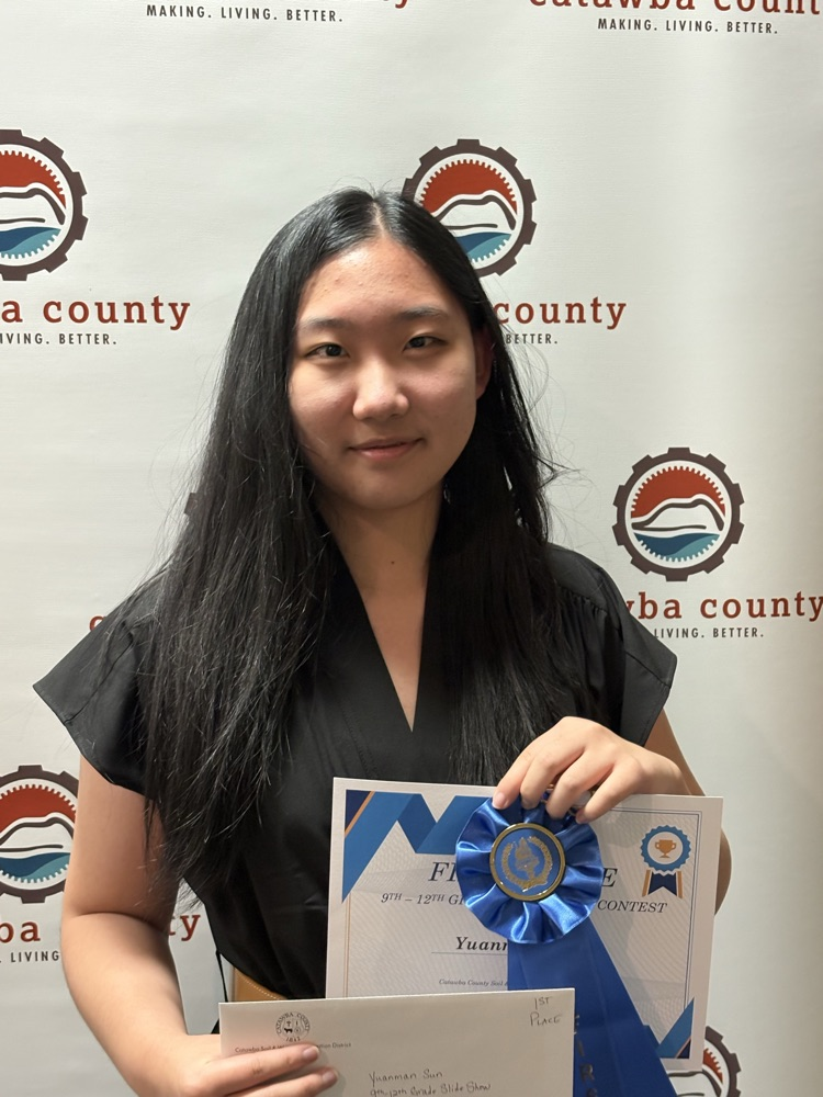 Yuanman posing with her certificate