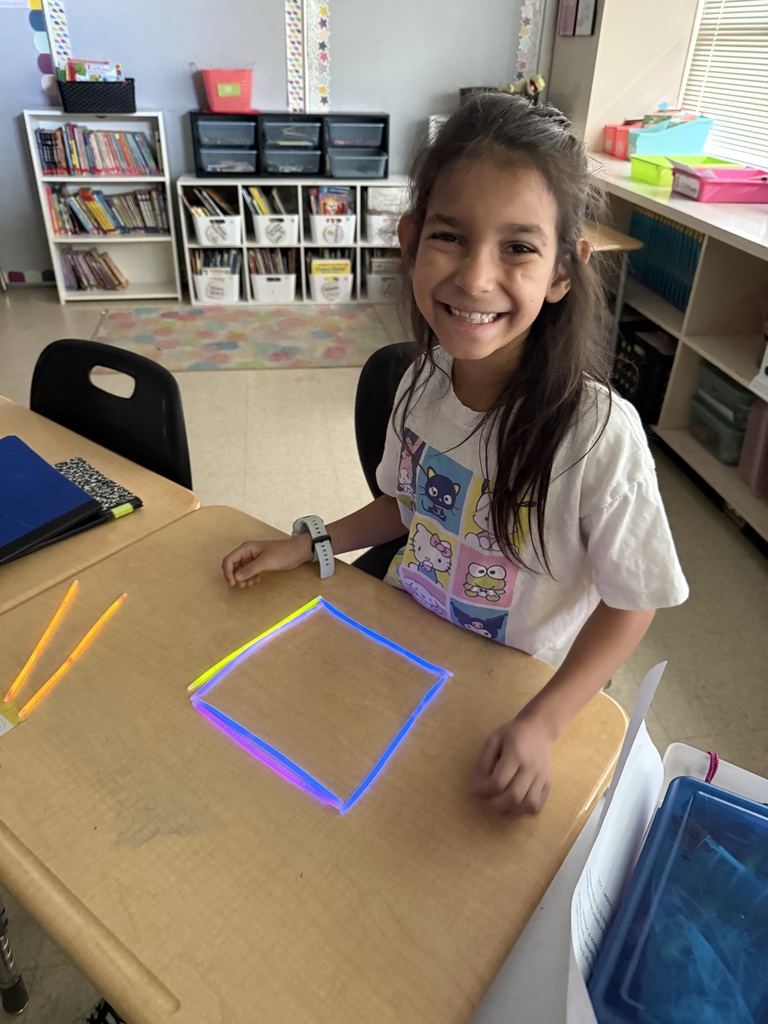Ms. Smyre's class lighting up learning with 2-D shapes.