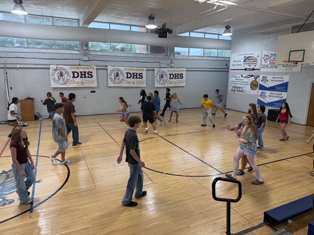 New students play a tag game while waiting on lunch