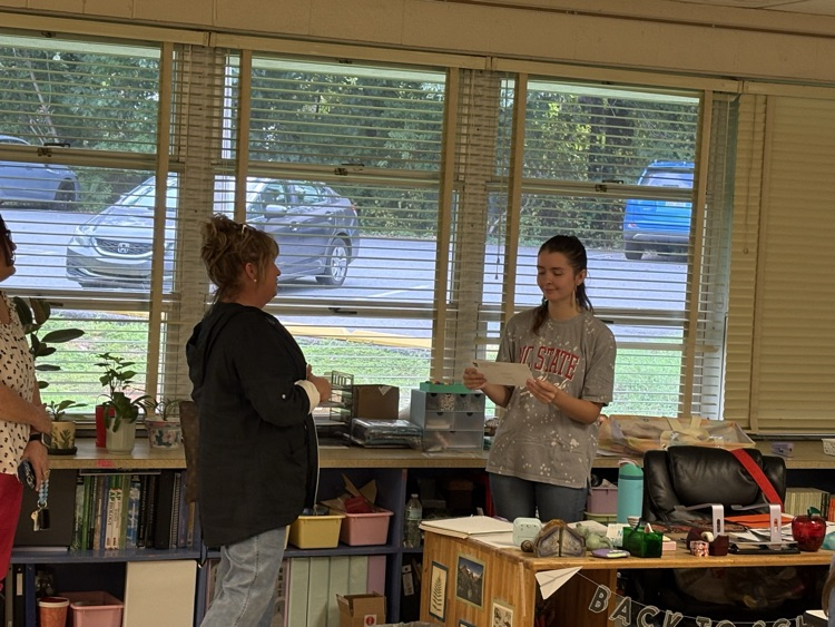 Representative of Shuford Credit Union presents gift certificate to Ms. Isenhour