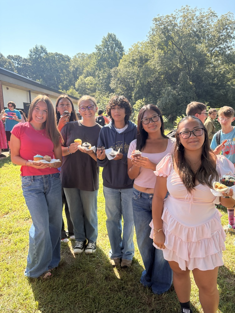 Students posing with their cupcakes