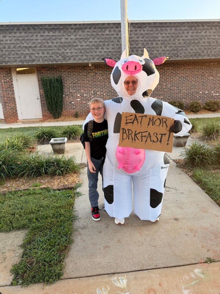 Nancy Price dressed up as a cow for World Milk Day - along with students