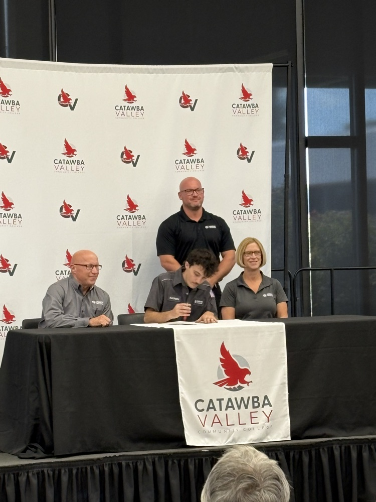 Anthony signs the apprenticeship agreement