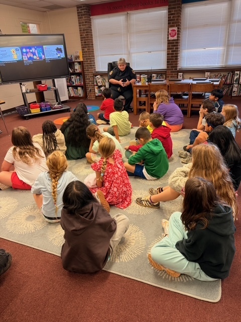 Officer G discussing internet and social media safety with 4th grade students at Shuford Elementary