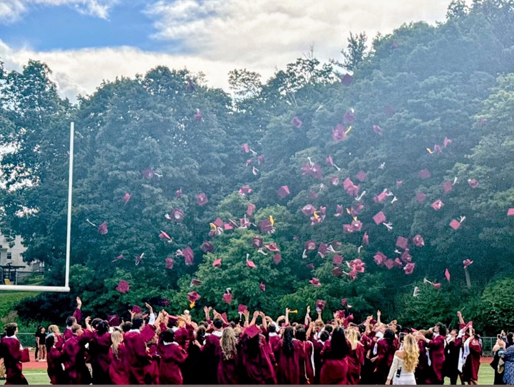 graduates throwing graduation caps