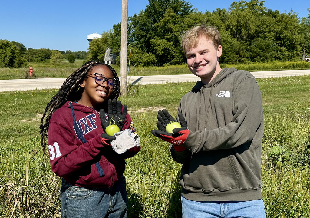 two students picking apples