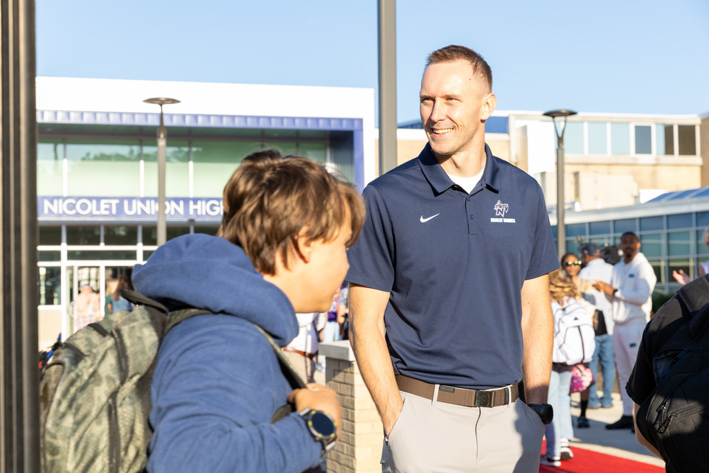 a principal talking with a student