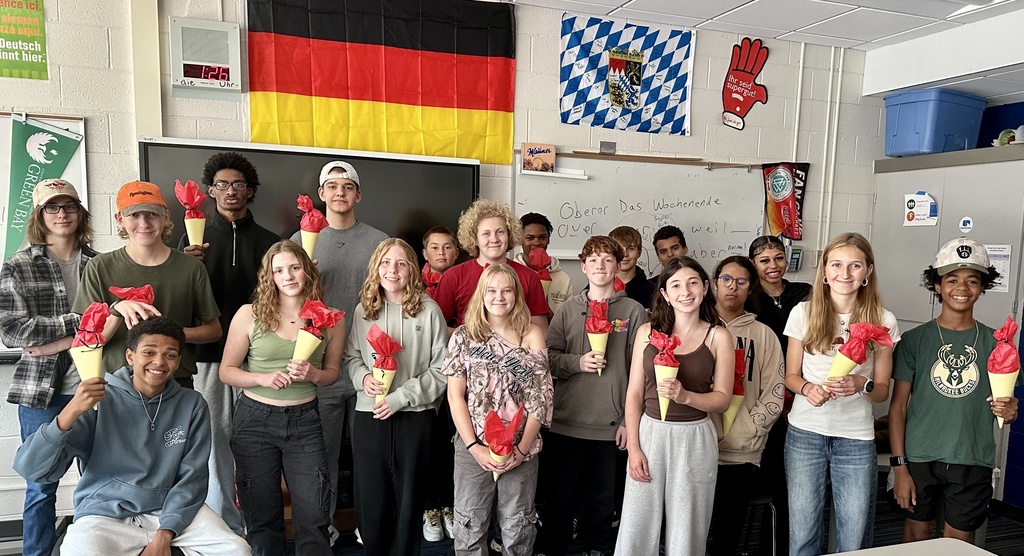 a picture of students holding flowers