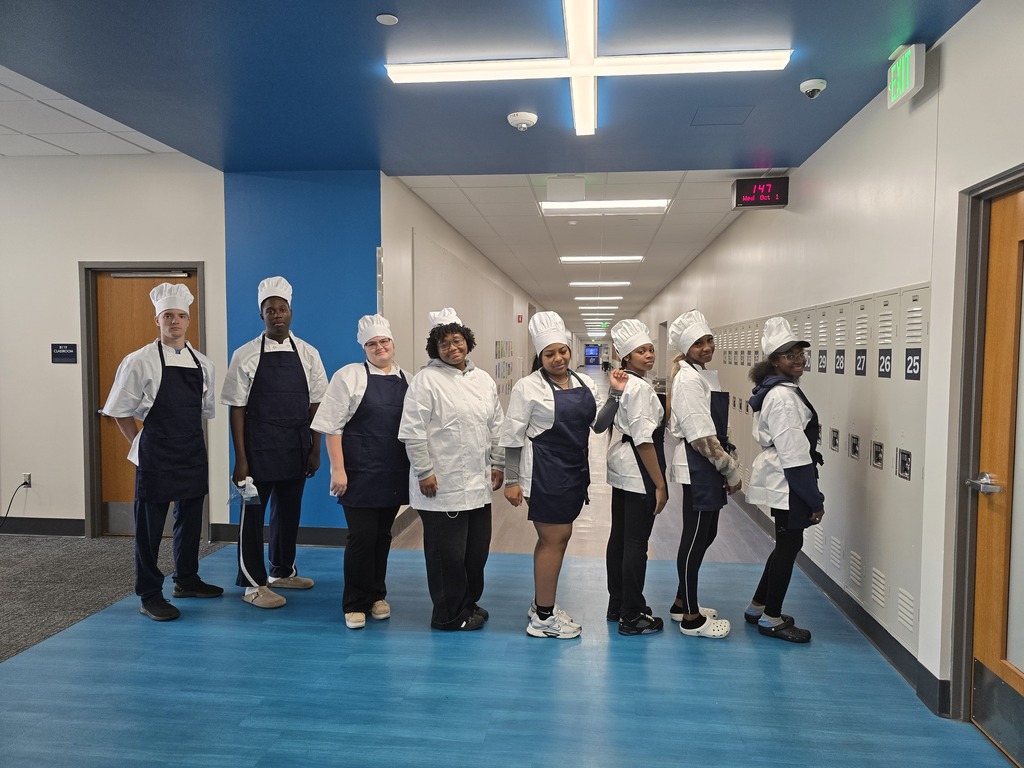a picture of students wearing chef attire