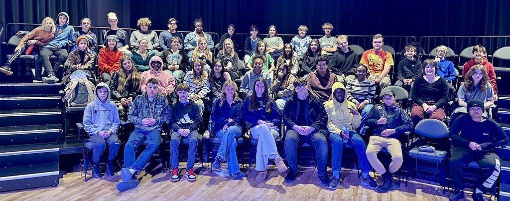 students smiling at a play