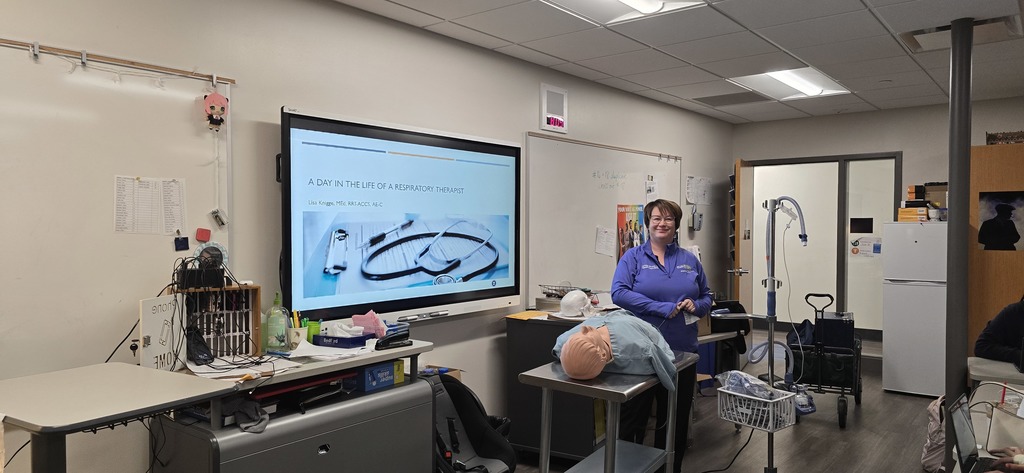  a nurse giving cpr to a mannequin 
