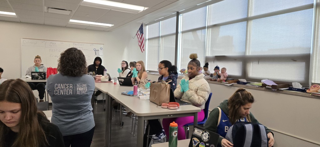 students listening to a teacher