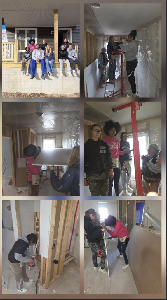 students working on building a house