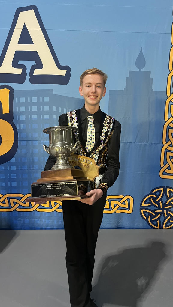 a picture of a student holding a trophy
