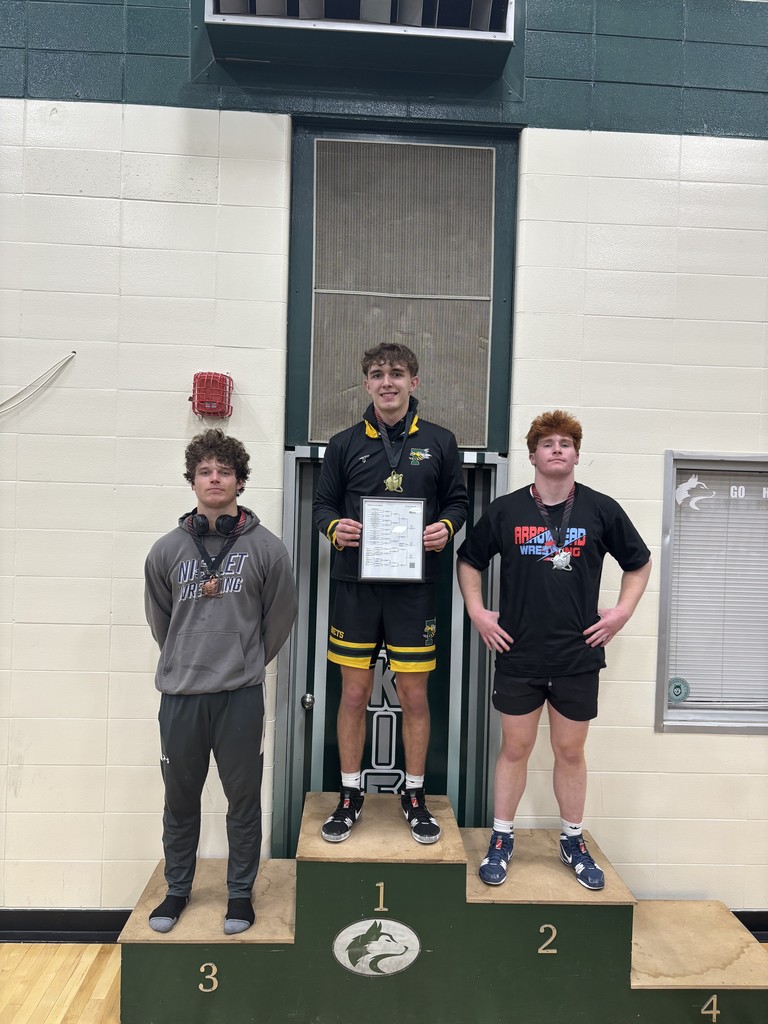 a picture of wrestlers holding a medal