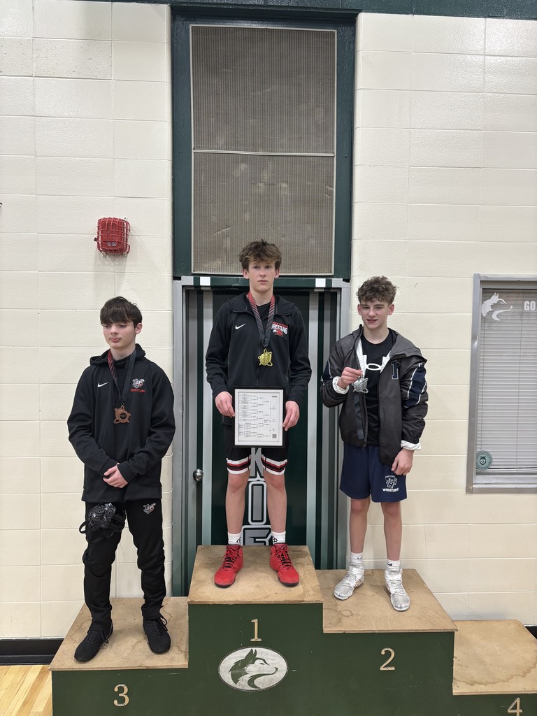 a picture of wrestlers holding a medal