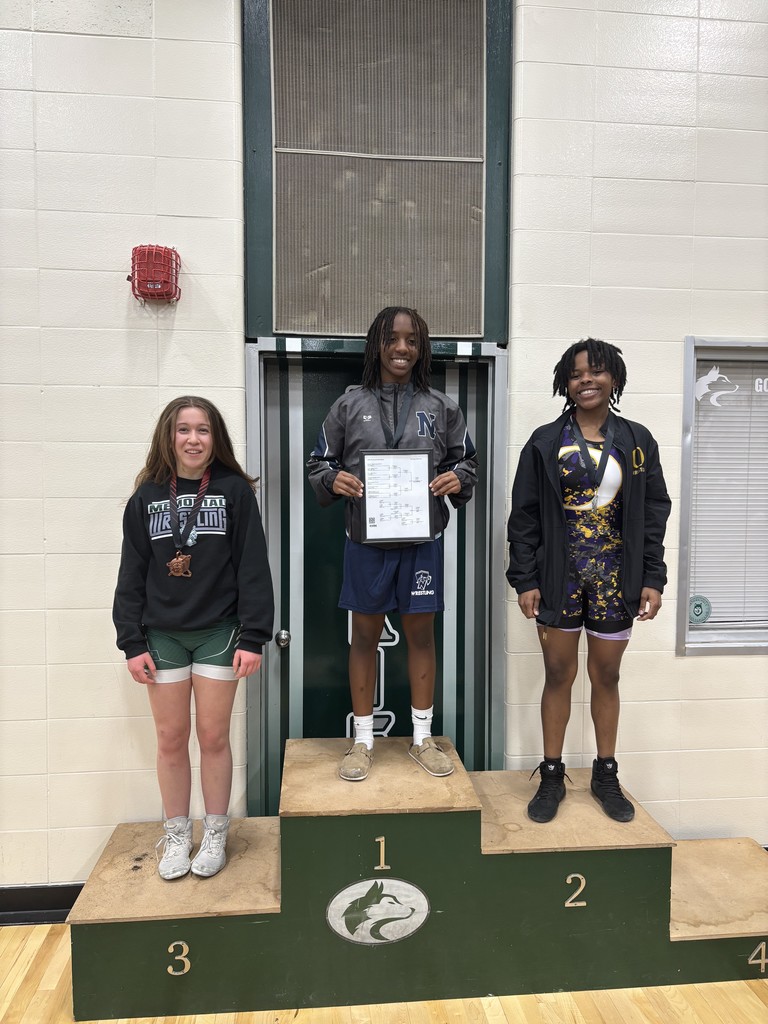 a picture of a girl wrestler holding a first place bracket