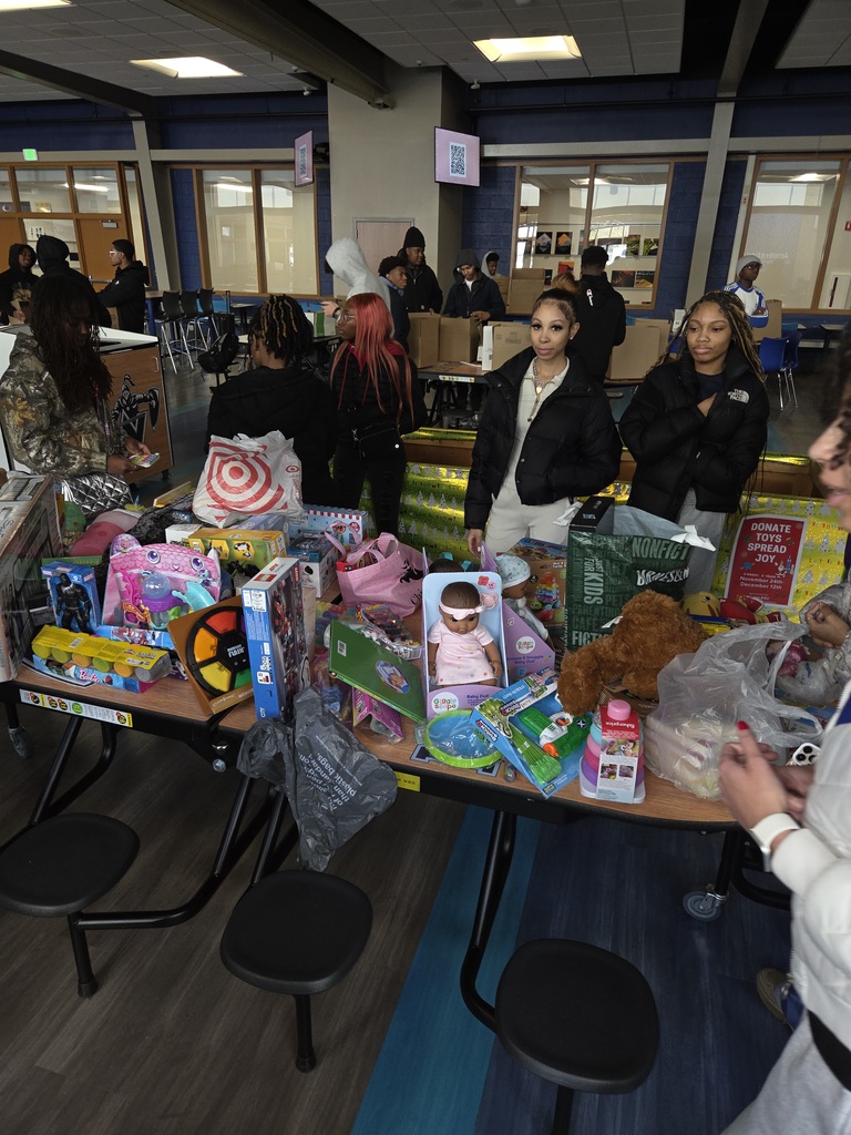 a picture of students organizing toys for a toy drive