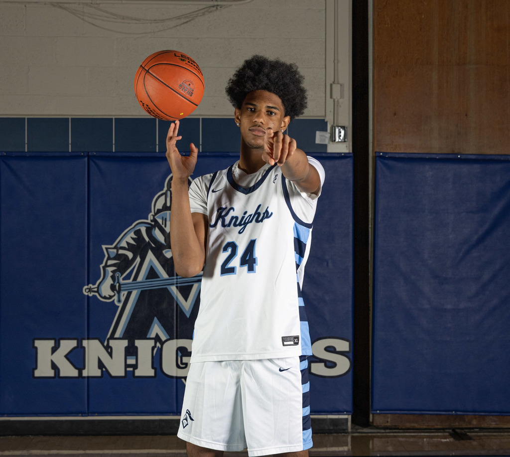  a picture of a basketball player pointing at the camera